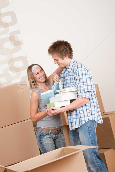 Moving house: Young couple with box in new home Stock photo © CandyboxPhoto