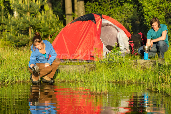 Camping couple heating supper and washing pot Stock photo © CandyboxPhoto