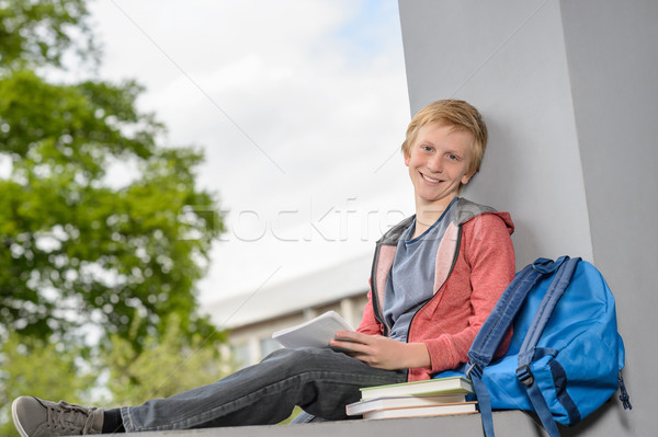 Happy boy studying sitting on wall campus Stock photo © CandyboxPhoto