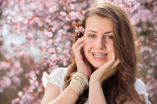 Romantic girl with braces near blossoming tree Stock photo © CandyboxPhoto