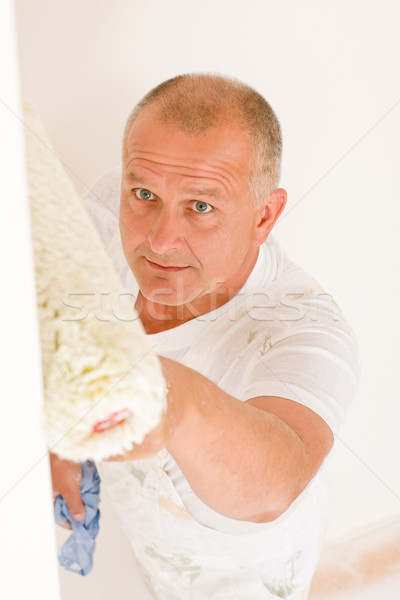 Home decorating mature man painting wall roller Stock photo © CandyboxPhoto