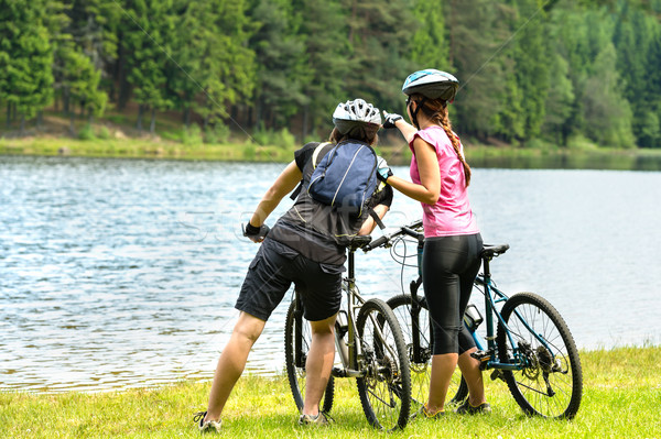 Young bikers at lake watching the forest Stock photo © CandyboxPhoto
