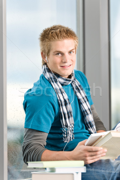 Young man with earbuds and books Stock photo © CandyboxPhoto