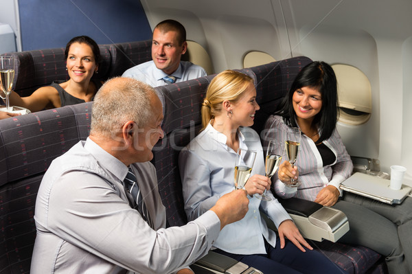 Airplane cabin businesspeople toasting champagne Stock photo © CandyboxPhoto