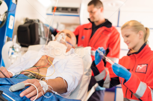 Stock photo: Sick patient with paramedic in ambulance treatment