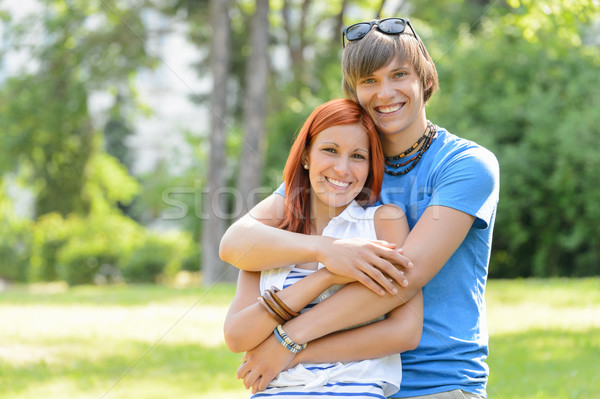 Teenage couple hugging in sunny park smiling Stock photo © CandyboxPhoto