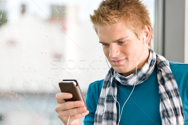 Male teenager with mp3 player and earbuds Stock photo © CandyboxPhoto