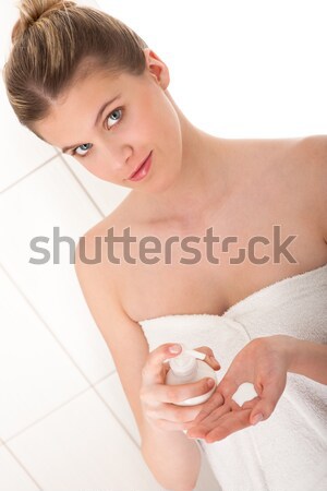 Body care: Young woman applying lotion in bathroom Stock photo © CandyboxPhoto