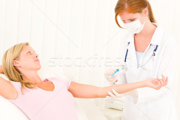 Stock photo: Medical doctor apply injection to woman patient