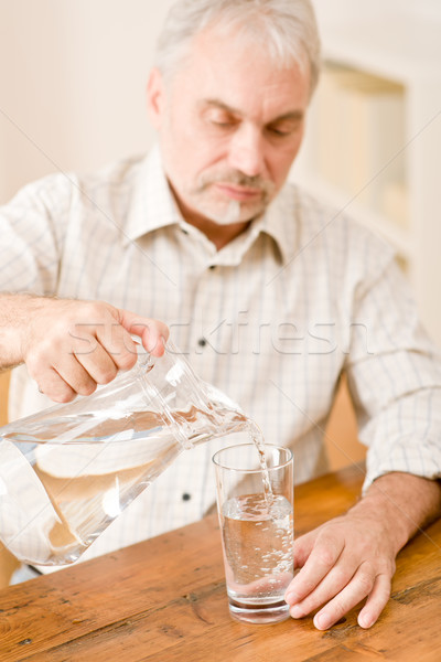 Starszy dojrzały mężczyzna wody posiedzenia tabeli Zdjęcia stock © CandyboxPhoto