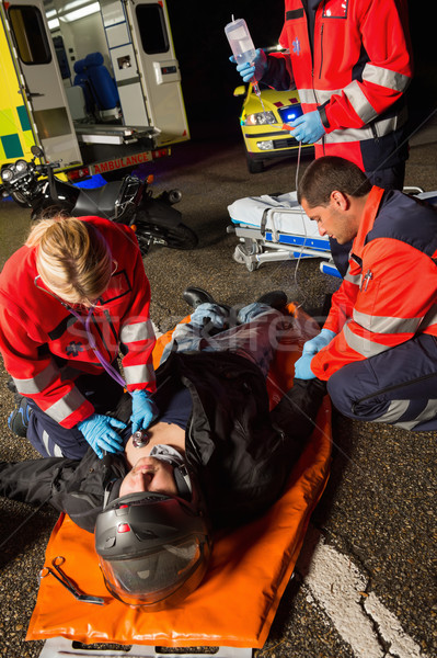 Paramedics examining injured motorcycle man driver Stock photo © CandyboxPhoto