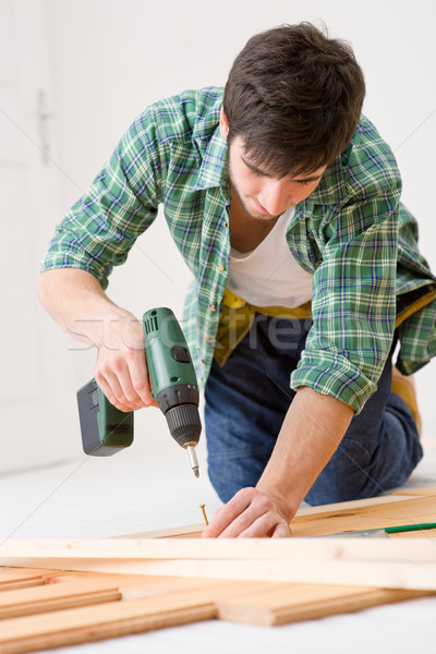 Home improvement - handyman installing wooden floor Stock photo © CandyboxPhoto