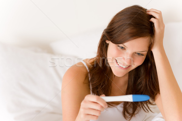 Stock photo: Pregnancy test - happy surprised woman
