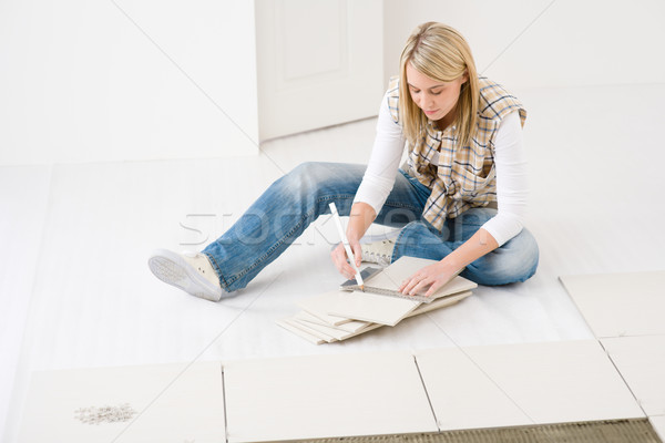 Home improvement - handywoman measuring tile Stock photo © CandyboxPhoto