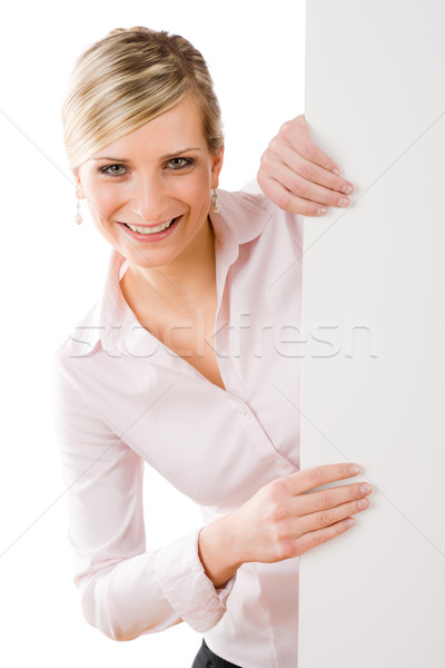 Stock photo: Happy businesswoman behind empty banner