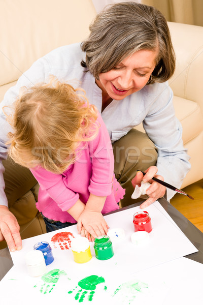 Little girl with grandmother play paint handprints Stock photo © CandyboxPhoto