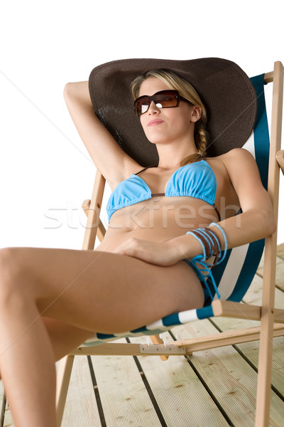 Beach - Young woman in bikini sitting on deck chair Stock photo © CandyboxPhoto