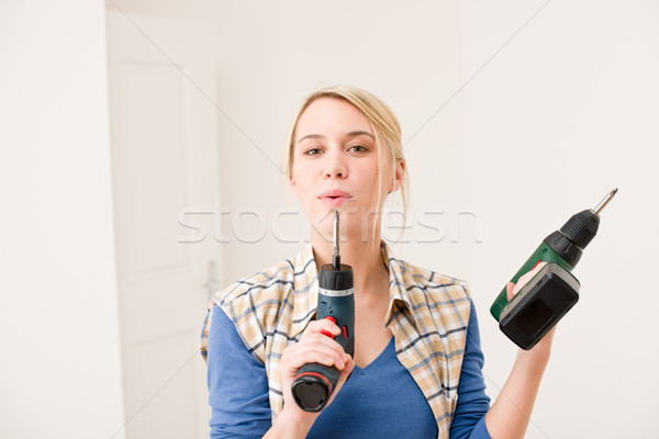 Stock photo: Home improvement - woman with battery screwdriver