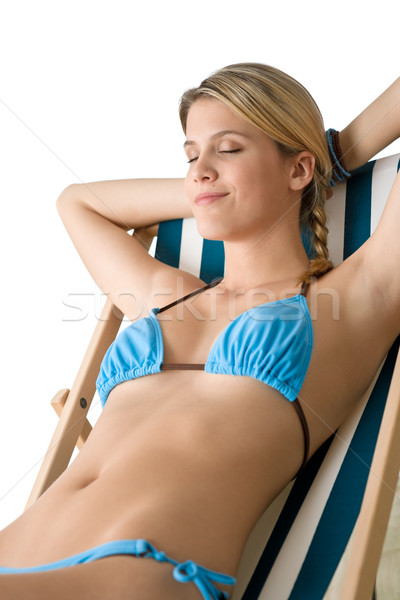 Beach - Young woman in bikini sitting on deck chair Stock photo © CandyboxPhoto