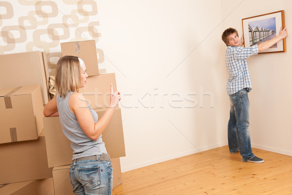 Moving house: Couple hanging picture on wall Stock photo © CandyboxPhoto