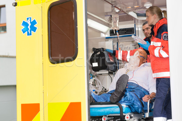 Paramedics checking IV drip patient in ambulance Stock photo © CandyboxPhoto