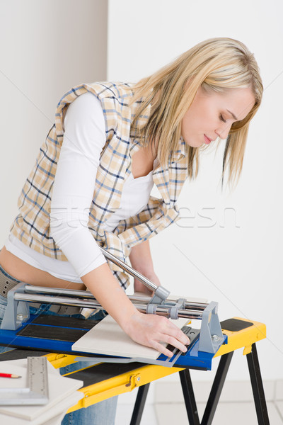 Home improvement - handywoman cutting tile Stock photo © CandyboxPhoto