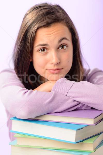 Stock photo: Desperate student girl leaning on stack books