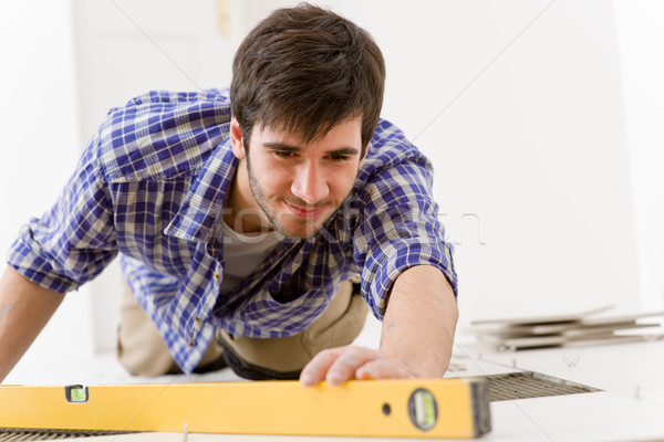 Home tile improvement - handyman with level Stock photo © CandyboxPhoto