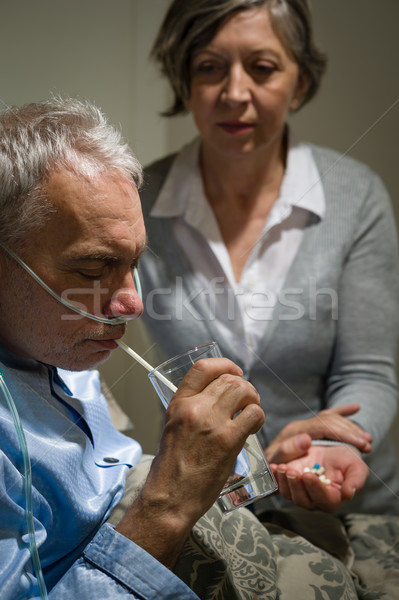 Caring senior wife holding drugs for husband Stock photo © CandyboxPhoto