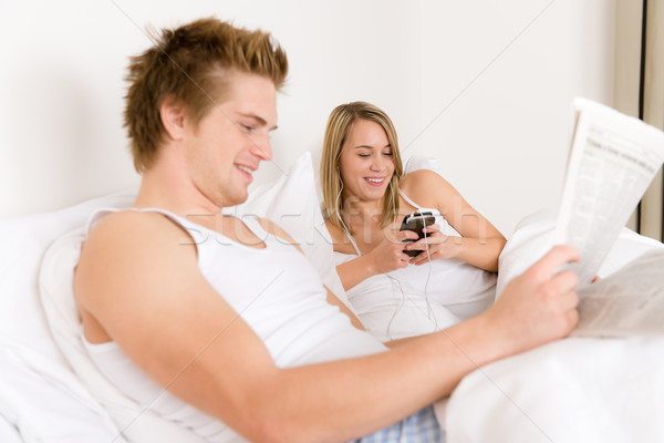 Young couple relax in bed listen to music Stock photo © CandyboxPhoto