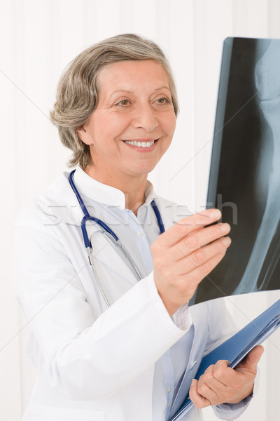 Senior doctor female smiling hold x-ray Stock photo © CandyboxPhoto