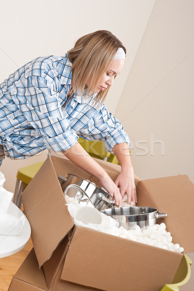 Moving house: Woman unpacking box with pot Stock photo © CandyboxPhoto