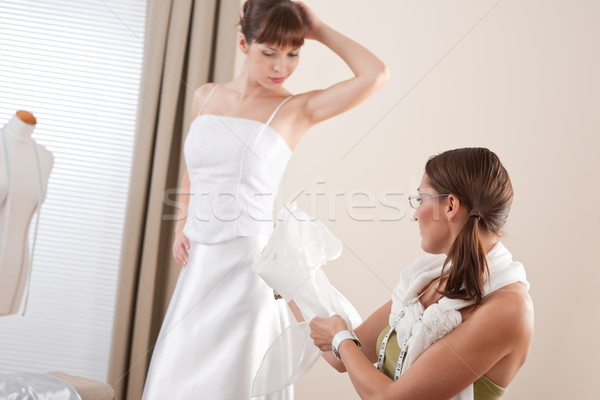 Fashion model fitting white wedding dress by designer Stock photo © CandyboxPhoto