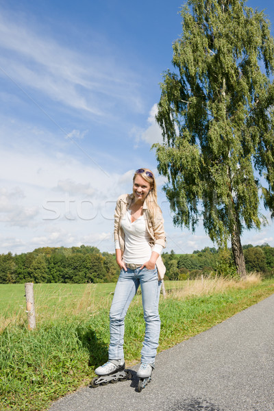Inline skating young woman on sunny asphalt road Stock photo © CandyboxPhoto