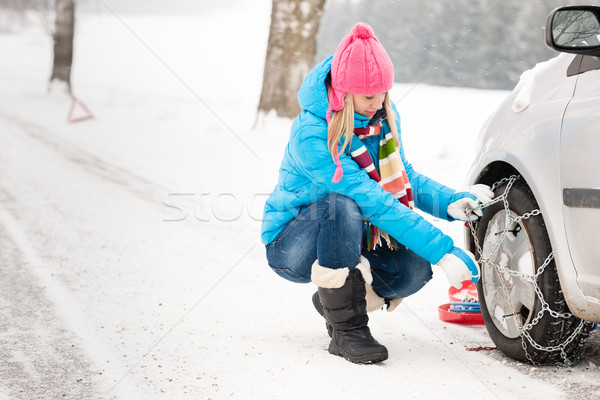 Woman putting winter tire chains car wheel Stock photo © CandyboxPhoto