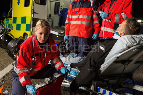 Paramedics assisting injured motorcycle man driver Stock photo © CandyboxPhoto