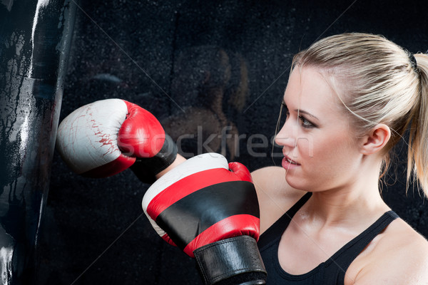 Stock photo: Boxing training woman with punching bag in gym