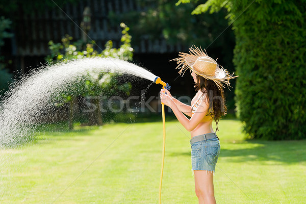 Stock photo: Summer garden woman play with water hose
