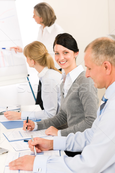 Stock photo: Giving presentation young woman during meeting