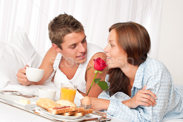 Happy man and woman having breakfast in bed together Stock photo © CandyboxPhoto