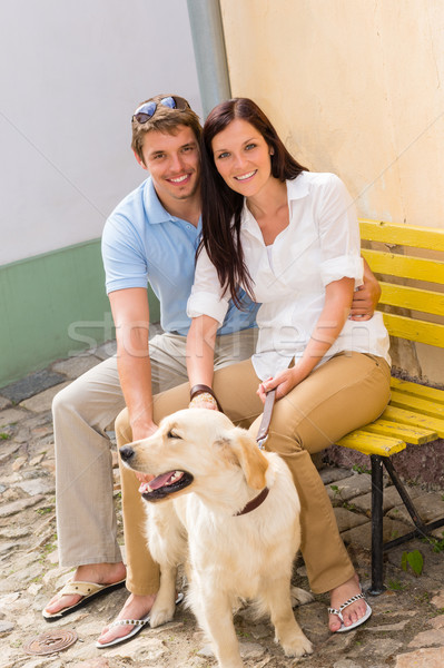 Happy couple with dog sitting yellow bench Stock photo © CandyboxPhoto