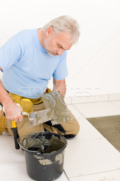 Home improvement, renovation - handyman laying tile Stock photo © CandyboxPhoto