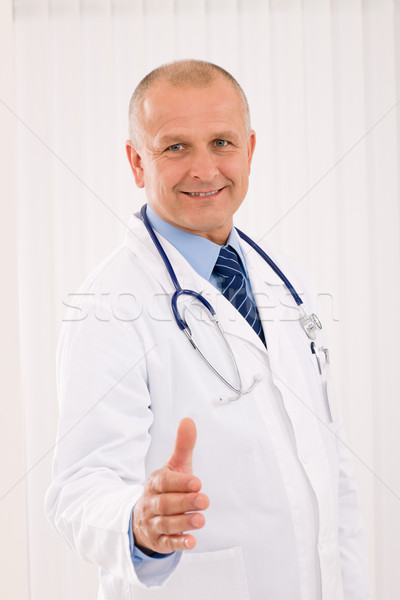 Senior doctor male smiling welcoming handshake Stock photo © CandyboxPhoto