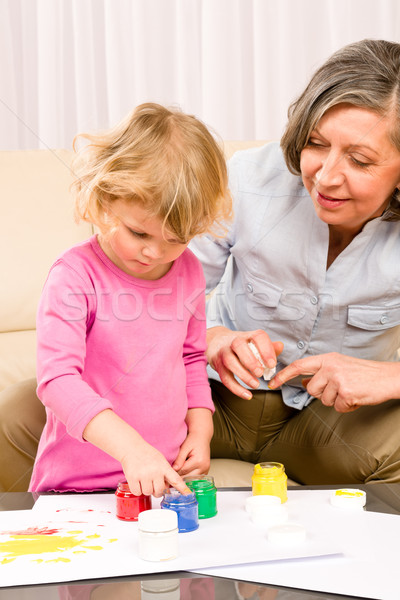 Little girl with grandmother play paint handprints Stock photo © CandyboxPhoto