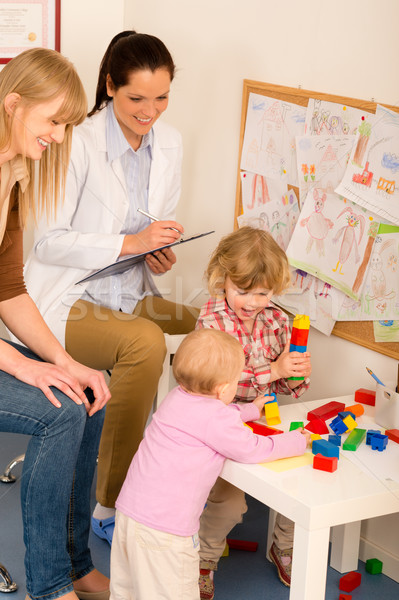 Pediatrician female review children play activity Stock photo © CandyboxPhoto