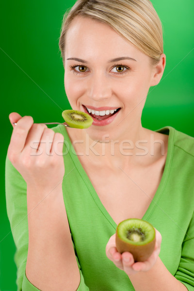 Healthy lifestyle - happy woman holding kiwi and teaspoon Stock photo © CandyboxPhoto