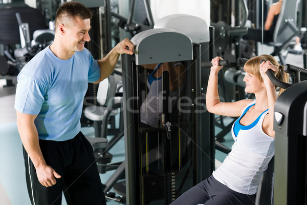 Young woman exercise on shoulder press machine Stock photo © CandyboxPhoto
