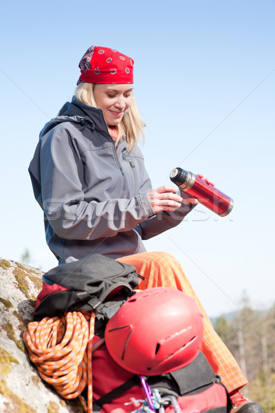 Active woman rock climbing with thermosbottle Stock photo © CandyboxPhoto