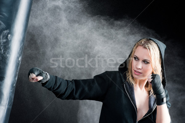 Blond boxing woman in black punching bag Stock photo © CandyboxPhoto