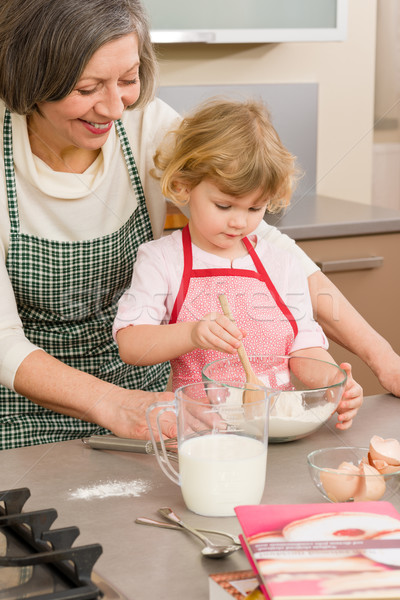 Child girl and grandmother baking cake Stock photo © CandyboxPhoto